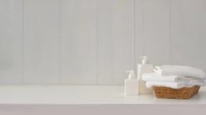 image with soap dispensers and some towels in a small basket