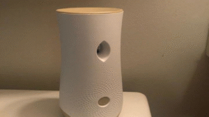 A white air freshener on a table