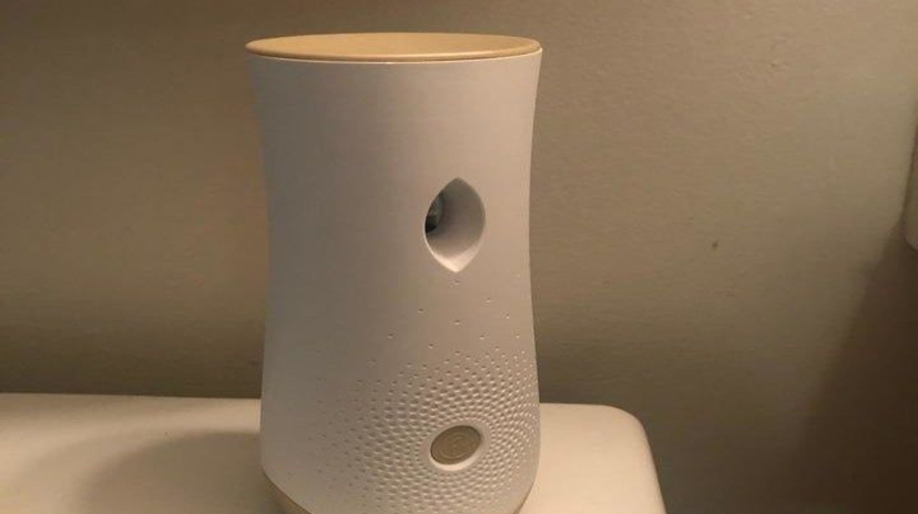 A white air freshener on a table